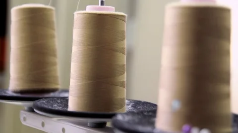 Plastic spools of cotton thread on sewing machine spindle, close-up Stock-Footage 88381698