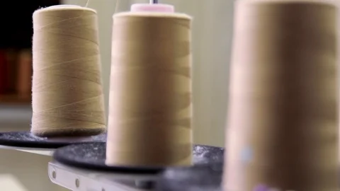 Plastic spools of cotton thread on sewing machine spindle, close-up Stock Footage 88381702
