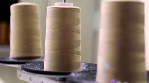 Plastic spools of cotton thread on sewing machine spindle, close-up Stock-Footage 88381705