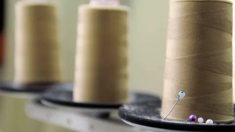 Plastic spools of cotton thread on sewing machine spindle, close-up Stock-Footage 88381707