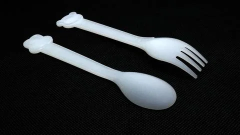 Plastic spoon and fork isolated on black background Stock Photos