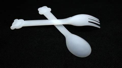Plastic spoon and fork isolated on black background Stock Photos