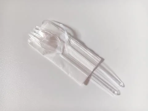 Plastic spoon and fork with tissue isolated on white background. Foto stock