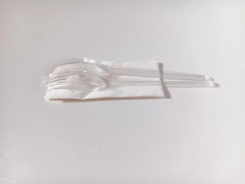 Plastic spoon and fork with tissue isolated on white background. Stock Photos