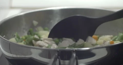 Plastic spoon stirring poultry with vegetables 5.7K video Stock Footage 300445752