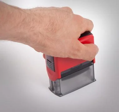 Plastic stamp in hand, isolated Stock Photos