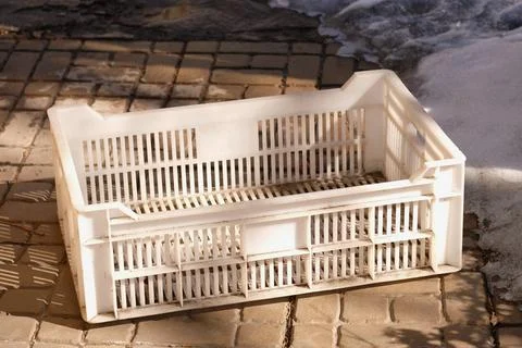 Plastic storage box stands on paving slabs Stock Photos