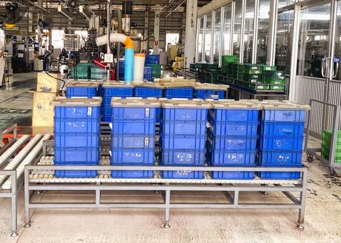 Plastic Storage Containers on Conveyor System in Manufacturing Factor Stock Photos
