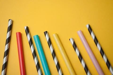 Plastic straw collection on yellow background Stock Photos