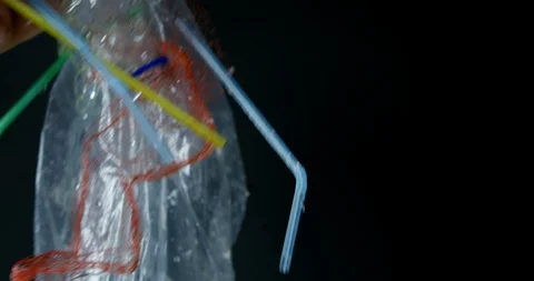 Plastic Straws And Packaging Picked Up By Out Of Water With Dark Background  Stock Footage 113383929