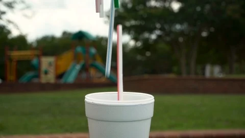 Plastic Straws dropped one by one into Styrofoam cup 스톡 동영상 91748918