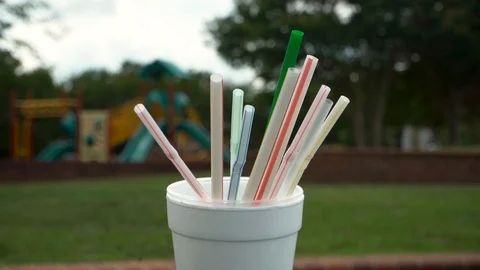 Plastic Straws dropped in a Styrofoam Cup Stock Footage 91748862