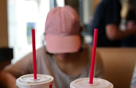 Plastic straws inside eating establishments are slowly being banned due to po Stock Photos