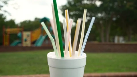 Plastic Straws placed into a Styrofoam Cup Stock Footage
