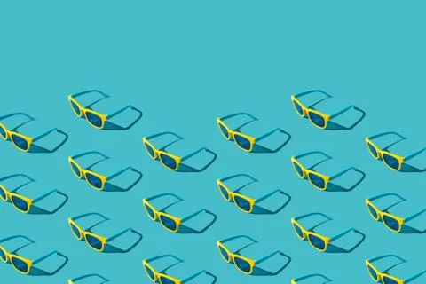 Plastic sunglasses pattern on turquoise blue background with hard shadow Stock Photos