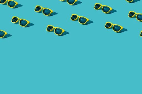 Plastic sunglasses pattern on turquoise blue background with copy space Stock Photos