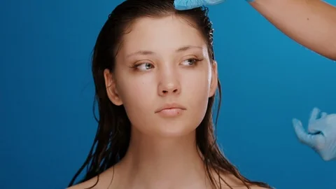 Plastic surgeon checking and measuring woman face before operation on blue Stock Footage 125055900