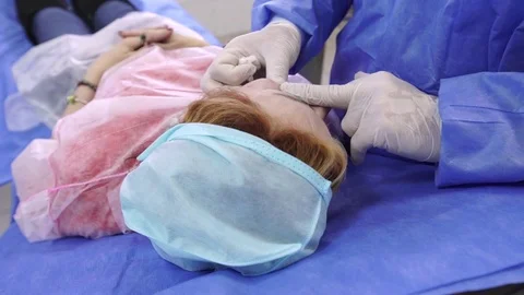 Plastic surgeon does massage after anti-aging injection Stock Footage 75447861