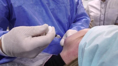 Plastic surgeon doing anti-aging injections Stock Footage 75447330