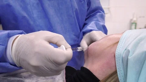 Plastic surgeon doing anti-aging injections Stock Footage 75447499