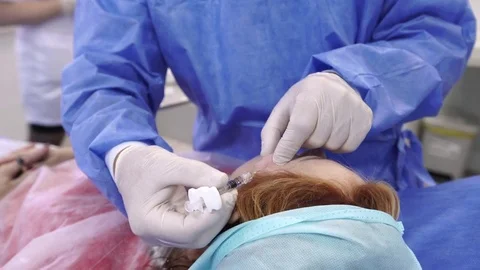 Plastic surgeon doing anti-aging injections Stock Footage 75447589