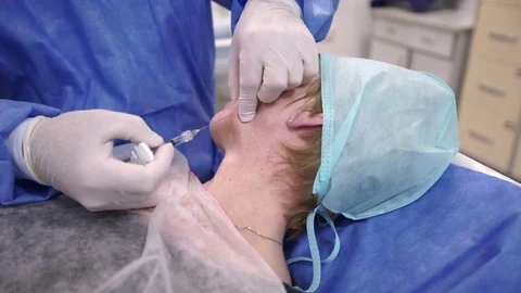 Plastic surgeon doing anti-aging injections Stock Footage 75447693