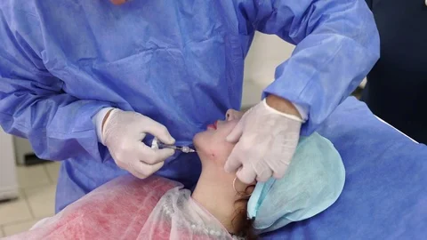 Plastic surgeon doing anti-aging injections Stock Footage 75447806