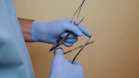 A plastic surgeon holds instruments in his hands before surgery. Stock Footage 142554011