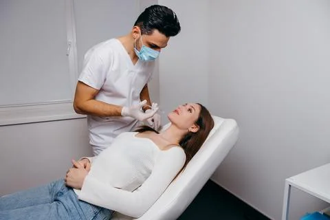 Plastic surgeon making marks by pencil on patient body Stock Photos