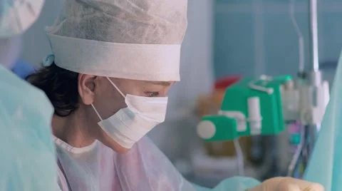 Plastic surgeon suturing breast after reimplantation Stock-Footage 68930811