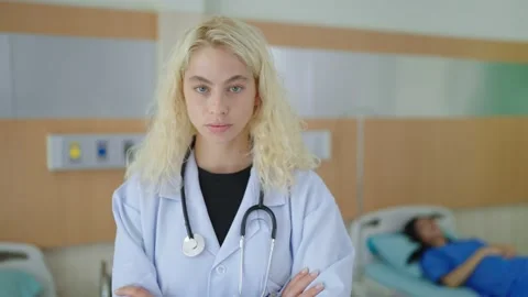 Plastic surgeon in white uniform standing with arms crossed looking at camera Stock-Footage 234180936