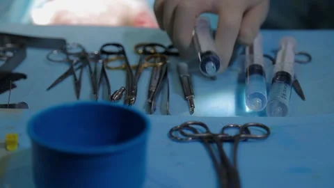 The plastic surgeon's hand picks up the instrument during the operation 動画素材 148046541