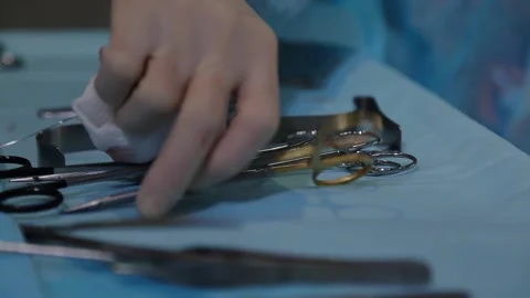 The plastic surgeon's hand picks up the instrument during the operation 動画素材 148046587