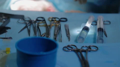 The plastic surgeon's hand picks up the instrument during the operation 動画素材 148046635