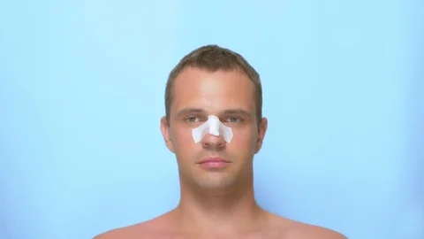 Plastic surgery concept, hands holding a man's face. a man after a plastic Stock Footage 112094989