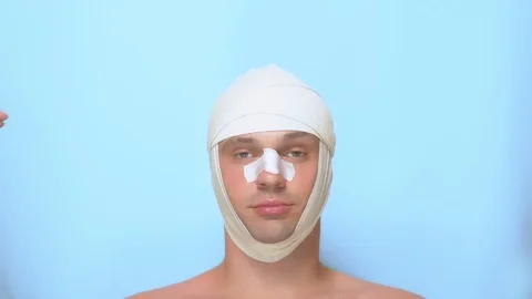 Plastic surgery concept, hands holding a man's face. a man after a plastic Video stock 112721345