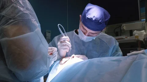 Plastic surgery on the face. Correction of the eyelids. Surgeon makes an ope Stock Footage 124407194