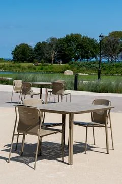 Plastic table and chairs outdoors in a green park, peaceful leisure concept Stock Photos