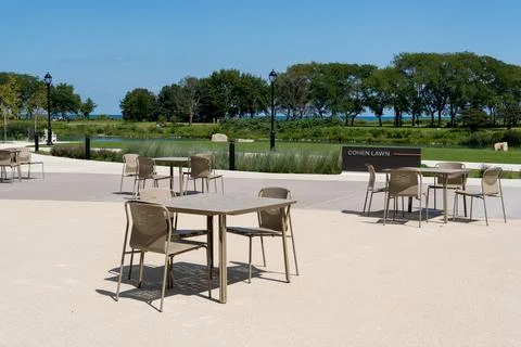 Plastic table and chairs outdoors in a green park, peaceful leisure concept Stock Photos