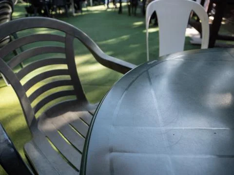 Plastic table and chairs set up outside. Stock Photos