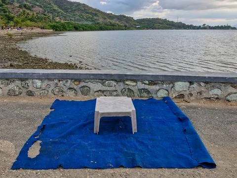A plastic table with a mat on the beach. Stock Photos
