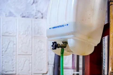 Plastic tank with minimum water level text and pipe Stock Photos