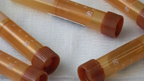 Plastic test tubes with brown caps for the collection of samples. Medical mod Stock Footage 166117835