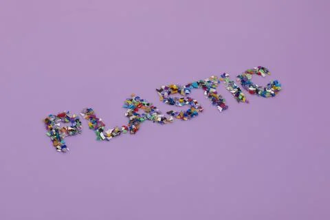 Plastic text consisting of small recycled plastic pellets Foto stock