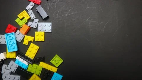 Plastic toy block on a black background Stock Photos