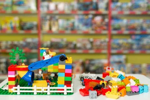 Plastic toy blocks on the white table in the store. Stock Photos