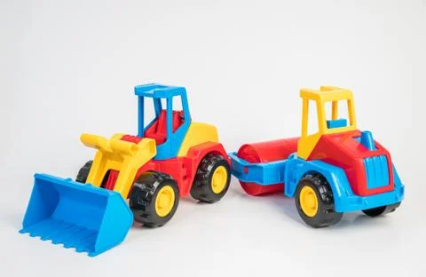 Plastic toy models of construction vehicles. Bulldozer and asphalt roller. Foto stock