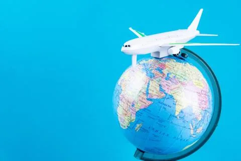 Plastic toy plane on the globe. Flight travel concept. Travel by airplane. Ta Stock Photos