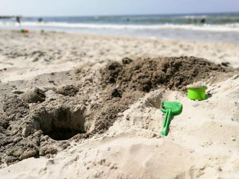 Plastic toy tools for digging sand on the beach Stock Photos