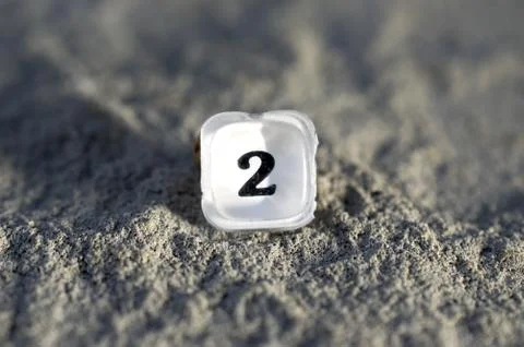 Plastic translucent button number 2 from an old calculator on a concrete back Stock Photos